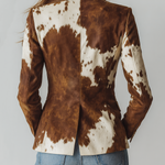 Woman wearing a vintage cow print blazer