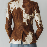 Woman wearing a vintage cow print blazer