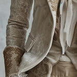 Woman wearing an ivory embroidered blazer