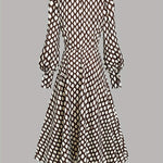 Woman wearing a rhombus print dress with belted waist