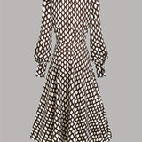 Woman wearing a rhombus print dress with belted waist