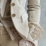 Woman wearing an ivory embroidered blazer