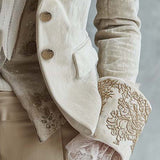 Woman wearing an ivory embroidered blazer