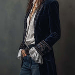 Woman wearing a long embroidered velvet jacket