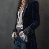 Woman wearing a long embroidered velvet jacket