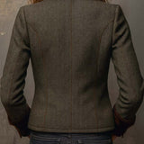 Woman wearing a herringbone blazer with contrast trim