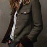 Woman wearing a herringbone blazer with contrast trim