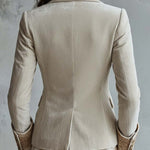 Woman wearing an ivory embroidered blazer