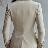 Woman wearing an ivory embroidered blazer