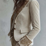 Woman wearing an ivory embroidered blazer