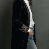 Woman wearing a long slim baroque print blazer