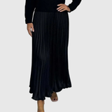 Woman wearing a maxi dress with a knit-look bodice and pleated skirt