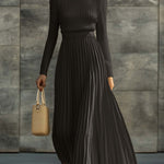 Woman wearing a knitted satin dress with pleated skirt