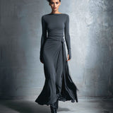 Woman wearing a long-sleeve maxi dress with an adjustable side tie