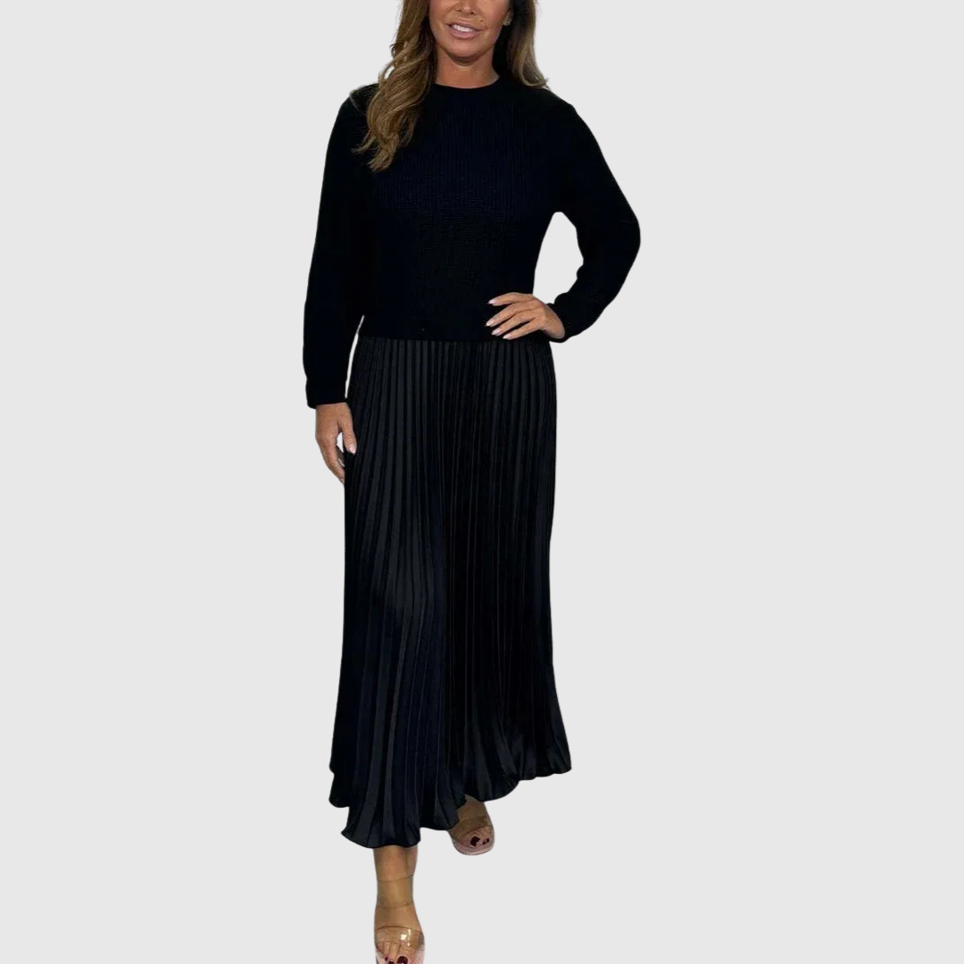 Woman wearing a maxi dress with a knit-look bodice and pleated skirt