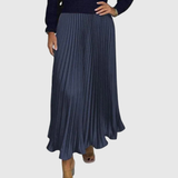 Woman wearing a maxi dress with a knit-look bodice and pleated skirt