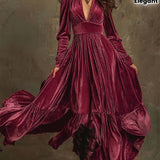 Woman wearing a deep V-neck pleated maxi dress