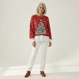 Sofia red patterned jumper worn full-length with white trousers