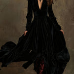 Woman wearing a deep V-neck pleated maxi dress