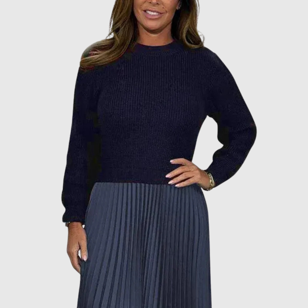 Woman wearing a maxi dress with a knit-look bodice and pleated skirt