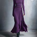 Woman wearing a long-sleeve maxi dress with an adjustable side tie