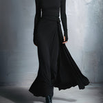Woman wearing a long-sleeve maxi dress with an adjustable side tie