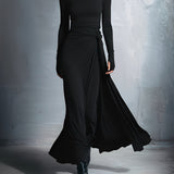 Woman wearing a long-sleeve maxi dress with an adjustable side tie