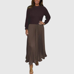 Woman wearing a maxi dress with a knit-look bodice and pleated skirt