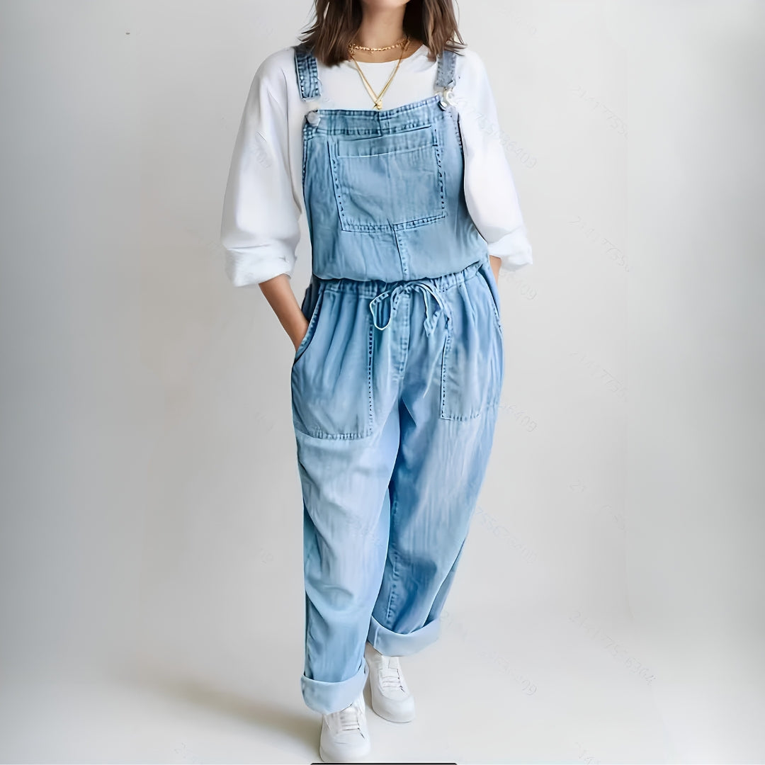 Woman wearing a loose-fit denim jumpsuit in a classic wash