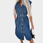 Woman wearing a sleeveless denim dress with a matching belt