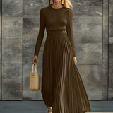 Woman wearing a knitted satin dress with pleated skirt