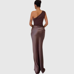 Woman wearing a one-shoulder satin maxi dress