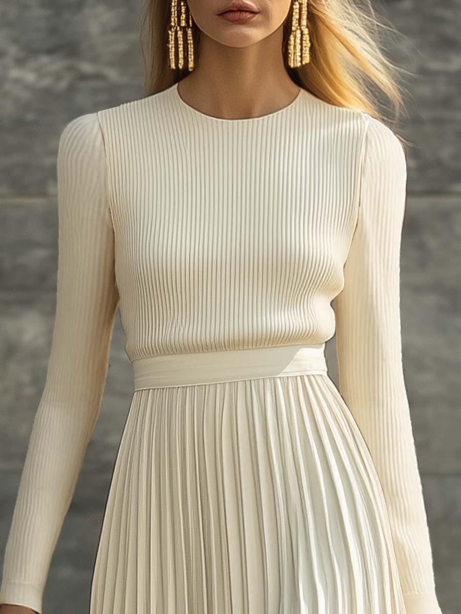 Woman wearing a knitted satin dress with pleated skirt