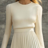 Woman wearing a knitted satin dress with pleated skirt