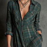 Woman wearing a full-length green plaid shirt dress with long sleeves