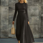 Woman wearing a knitted satin dress with pleated skirt