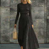 Woman wearing a knitted satin dress with pleated skirt