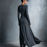 Woman wearing a long-sleeve maxi dress with an adjustable side tie
