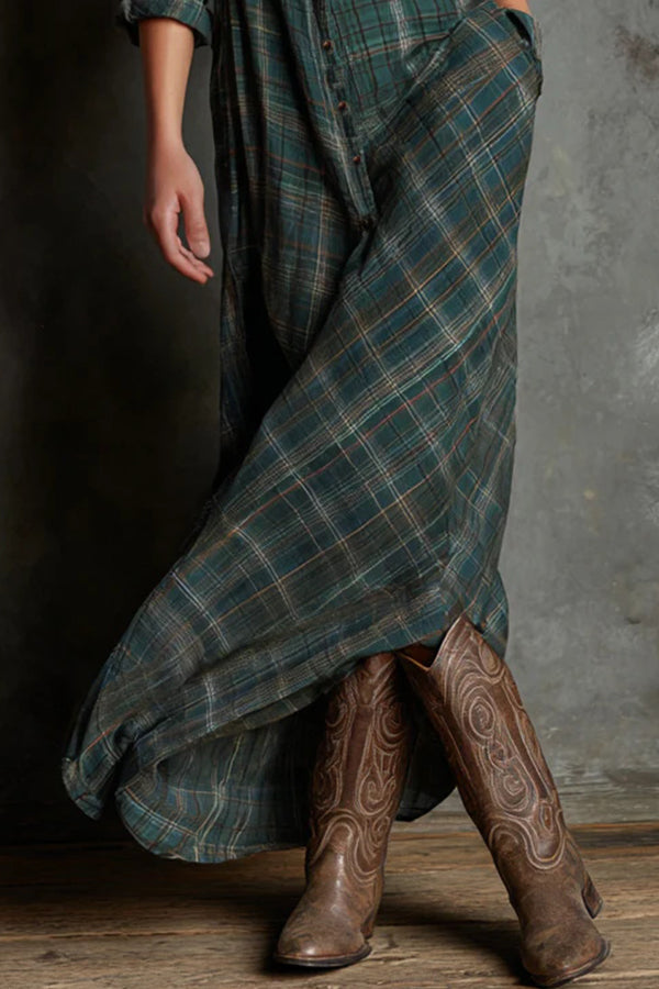 Woman wearing a full-length green plaid shirt dress with long sleeves