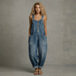 Woman wearing a wide-leg denim jumpsuit with adjustable straps and front pockets