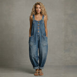 Woman wearing a wide-leg denim jumpsuit with adjustable straps and front pockets