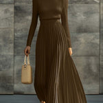 Woman wearing a knitted satin dress with pleated skirt