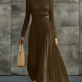 Woman wearing a knitted satin dress with pleated skirt