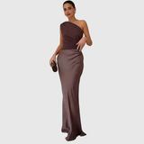 Woman wearing a one-shoulder satin maxi dress