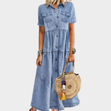 Woman wearing a long button-front denim dress with short sleeves