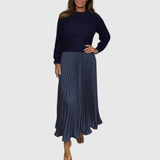 Woman wearing a maxi dress with a knit-look bodice and pleated skirt