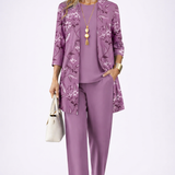 Woman wearing a purple three-piece cardigan set with wide-leg trousers