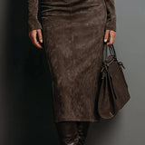Woman wearing a suede-effect high-neck midi dress