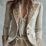 Woman wearing an ivory embroidered blazer
