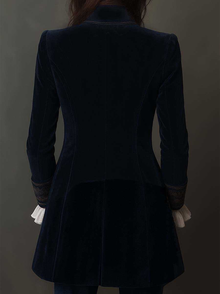 Woman wearing a long embroidered velvet jacket